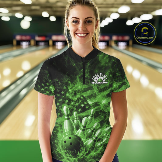Female model wearing a black and green bowling quarter-zip in a bowling lane with fiery bowling graphics and flag-inspired artwork.