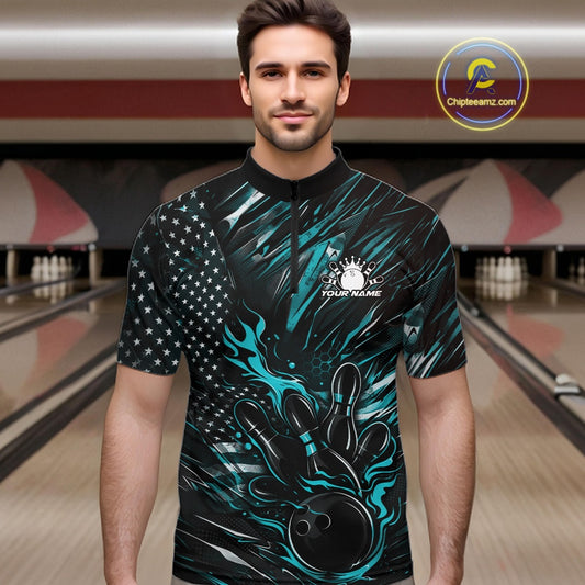 Male model at a bowling lane wearing a black and turquoise blue bowling quarter-zip shirt with fiery bowling strike artwork and patriotic graphics.