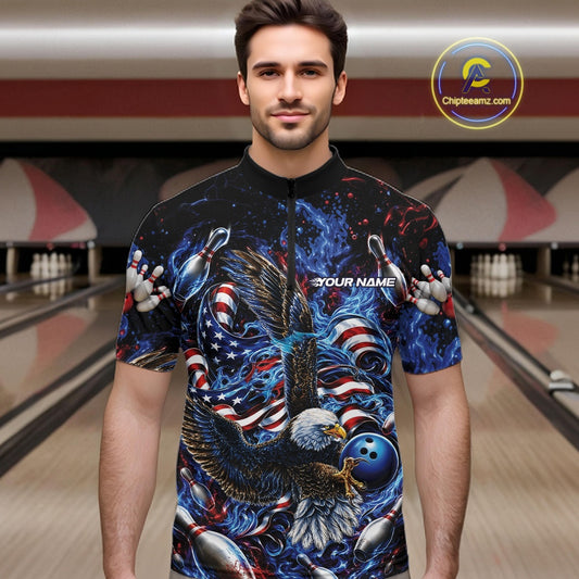Front view male model in a bowling lane wearing a quarter zip shirt with flaming bald eagle, blue bowling ball, American flag, and blue flames.