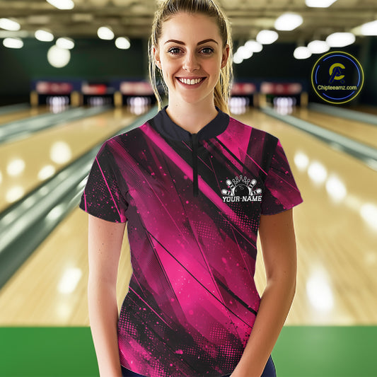 Woman wearing a pink and black bowling shirt with 'Your Name' printed on it, standing in a bowling alley.