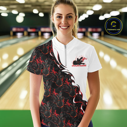 Front view of a female model in a bowling lane wearing a white quarter-zip shirt with red and black flame bowling pattern, featuring dynamic sporty bowling graphics.