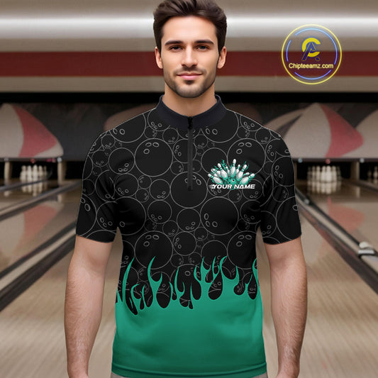 Male model in a bowling lane wearing black quarter zip shirt, front view showcasing bowling ball pattern with turquoise green flames and dynamic bowling artwork