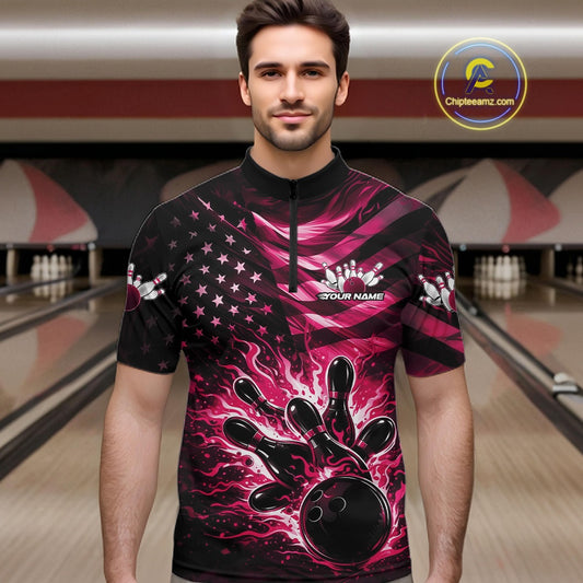 Male model wearing a black bowling quarter-zip shirt at the bowling lane with pink flame bowling graphics and patriotic flag accents.
