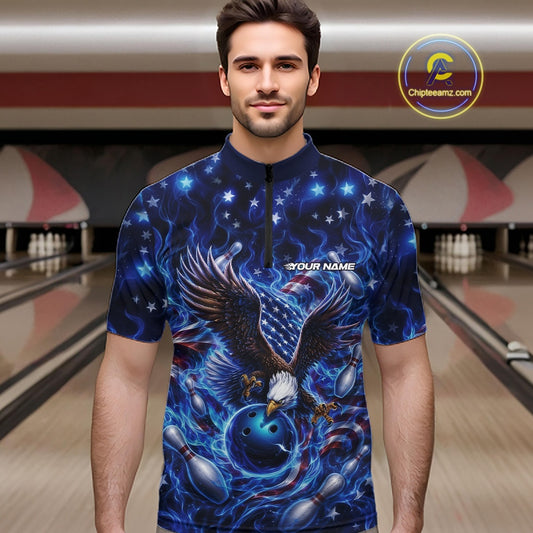 Front view of a male model in a bowling lane wearing a quarter zip shirt with eagle artwork, bowling ball, flag accents, pins, and blue flames.