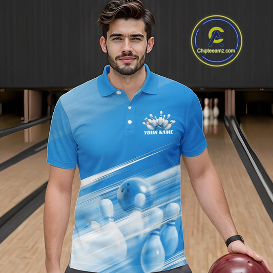 Male model front view at a bowling lane wearing a blue bowling polo shirt with bowling ball and pins over a pink geometric pattern.