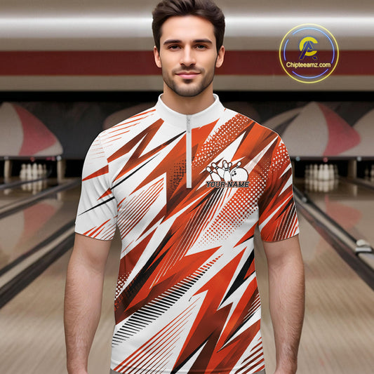 Man wearing a red and white bowling shirt with a pattern in a bowling alley.
