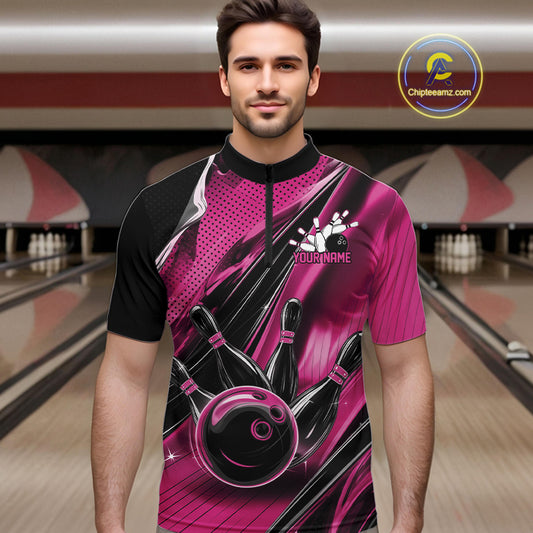 Male model wearing a black and pink bowling quarter-zip shirt at the bowling lane with fast-moving bowling strike graphics.