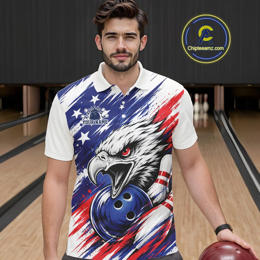 Man wearing a colorful polo shirt with an eagle and bowling ball design in a bowling alley.