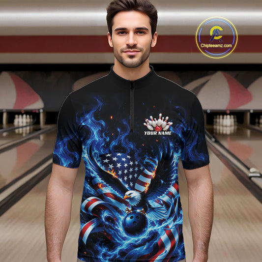 Front view of a male model in a bowling lane wearing a quarter zip shirt with flaming eagle motif, blue bowling ball, American flag, and blue flames.