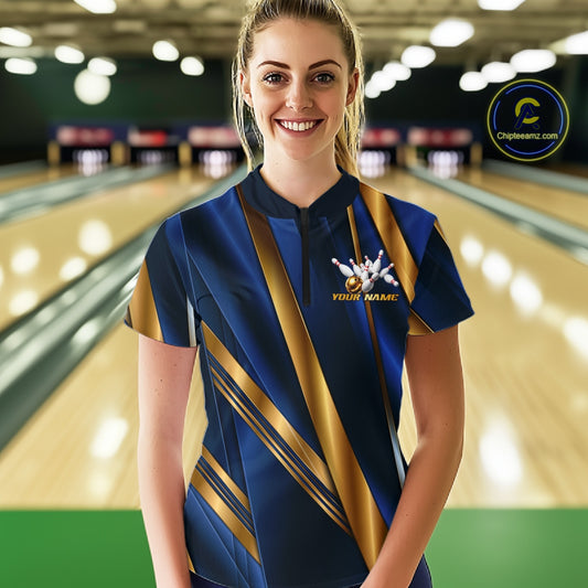 A woman stands in a bowling alley wearing a short-sleeve bowling shirt with a navy blue and gold geometric pattern, a white bowling pin graphic, and 'YOUR NAME' printed on the chest. A circular 'Championship.