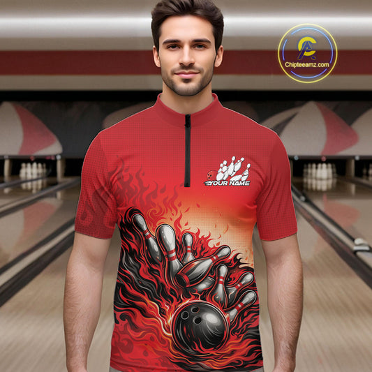 Male model in a bowling lane wearing a red quarter-zip shirt, flame bowling ball hitting pins with energetic fire-inspired graphics.