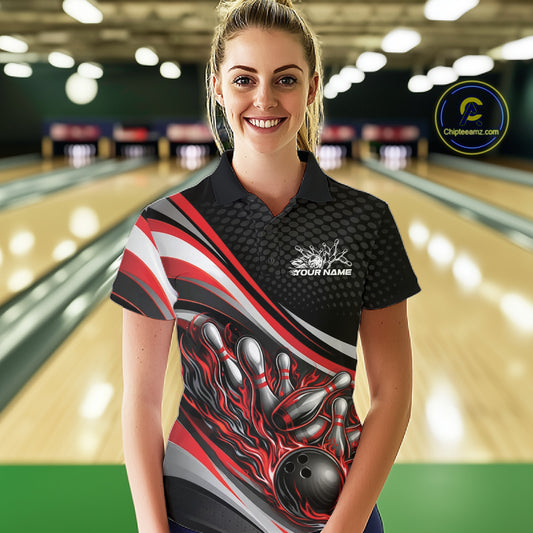 Female model at a bowling lane wearing a black and red polo shirt, fiery bowling ball hitting pins with intense sports graphics.