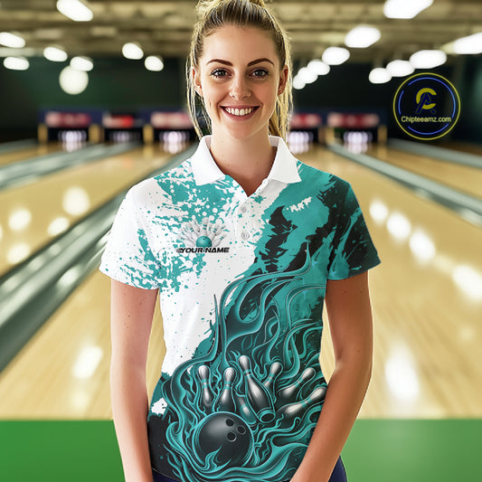 In bowling lane front view female model wearing bowling polo shirt, black turquoise blue and white scheme, flame bowling ball and pins artwork, dynamic sports lighting
