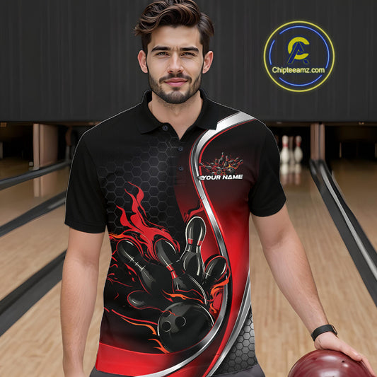 Male model seen from the front in a bowling lane wearing a black and red polo shirt featuring a flame bowling ball striking pins in an energetic action scene.