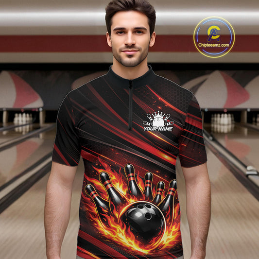Male model at a bowling lane wearing a black and red-orange bowling quarter-zip shirt with flaming bowling artwork and dynamic stripe details.