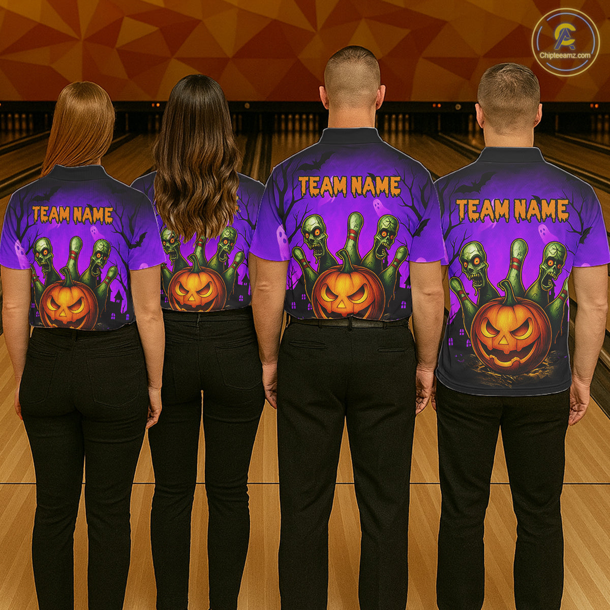 Four people standing with their backs to the camera in a bowling alley, wearing matching purple and black team shirts with a Halloween theme. The shirts feature a large orange jack-o'-lantern, green zombie heads, and the text 'TEAM NAME' 