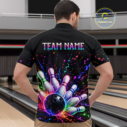 Person wearing a black bowling shirt with colorful design and 'TEAM NAME' text in a bowling alley.