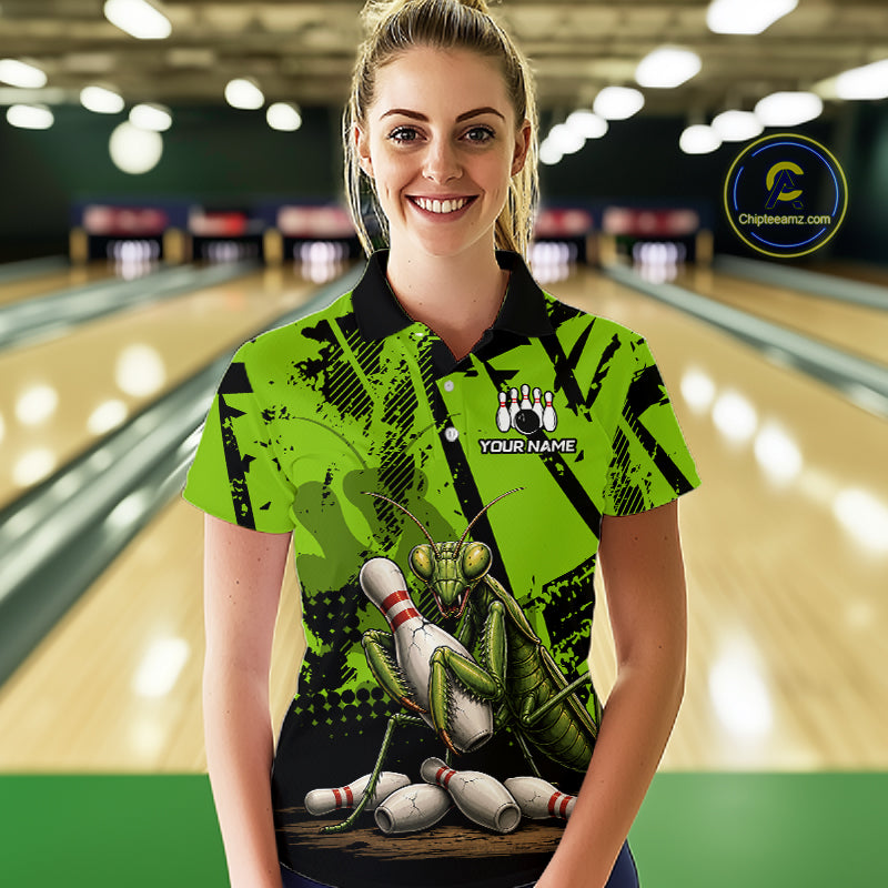 A woman wearing a bright lime green and black short-sleeve bowling-themed polo shirt with a large praying mantis graphic and bowling pins, standing in front of a blurred bowling alley background. 
