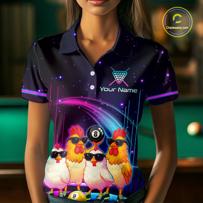 A woman wearing a dark navy blue short-sleeve polo shirt with a vibrant, colorful graphic print. The print features four cartoon chickens wearing sunglasses, billiard balls, and a pool cue design, with the text 'Your Name' on the chest.