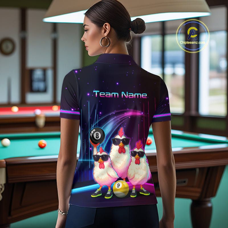 A woman stands in a billiards room wearing a custom short-sleeve polo shirt with a colorful graphic of three chickens wearing sunglasses and billiards-themed elements. The shirt features the text 'Team Name.