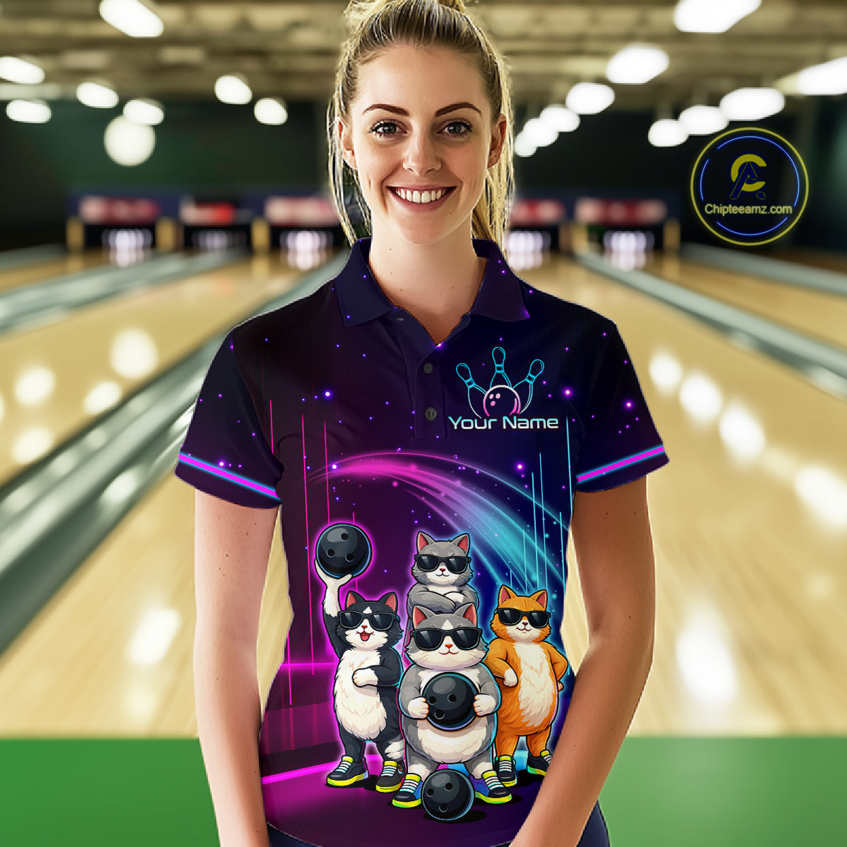 Person wearing a bowling-themed shirt with cartoon cats in a bowling alley.