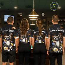 Load image into Gallery viewer, Four people wearing matching shirts with raccoon and pool ball designs in a room with a pool table.