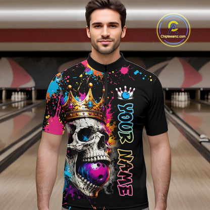Man wearing a colorful bowling shirt with a skull design in a bowling alley.