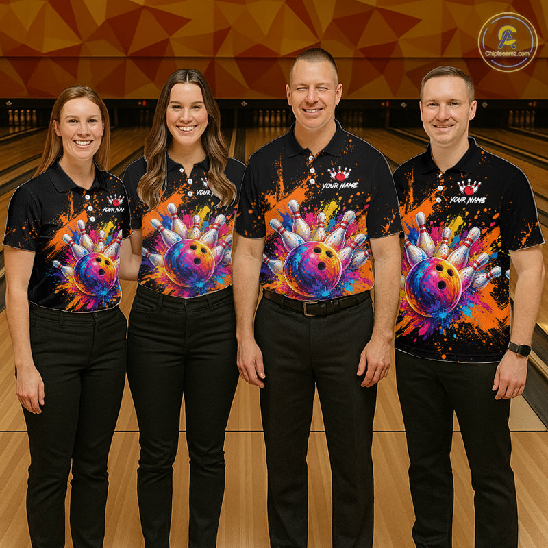 Four people standing together in a bowling alley wearing matching black polo shirts with a colorful bowling-themed graphic print on the front, paired with black pants.