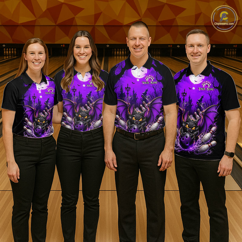 Four people standing in a bowling alley wearing matching black and purple bowling shirts with a bat graphic, paired with black pants. 