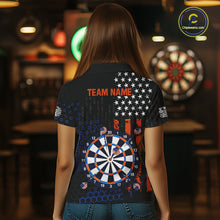 Load image into Gallery viewer, Back view of a female model wearing a custom black darts polo shirt featuring an American flag design, a large dartboard graphic, and 'TEAM NAME' printed in orange