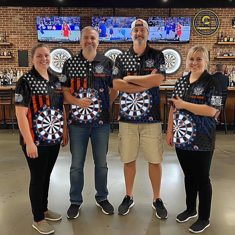 Group of four people in a sports bar wearing matching custom black darts team polo shirts featuring an American flag and dartboard design.