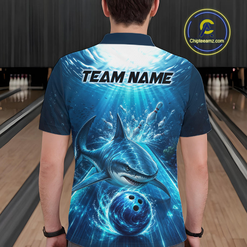 Person wearing a blue bowling shirt with a shark design and 'Team Name' text in a bowling alley.