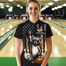 Load image into Gallery viewer, Person wearing a black shirt with a raccoon graphic and 'Your Name' text in a bowling alley.