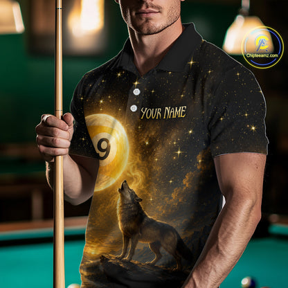 A man wearing a custom black polo shirt with a gold and yellow cosmic wolf design, holding a pool cue in a dimly lit pool hall. The shirt features a starry night sky, a large golden billiard ball with the number 9, and a howling wolf.