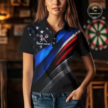 A woman wearing a custom dart polo shirt featuring a patriotic dartboard graphic with red, blue, and silver diagonal stripes in a professional dart room.