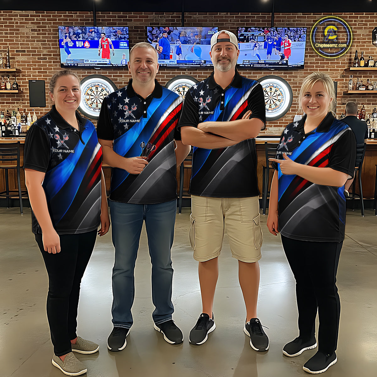 Group of four wearing matching custom dart polo shirts featuring patriotic dartboard graphics with red, blue, and silver diagonal stripes in a professional dart room.