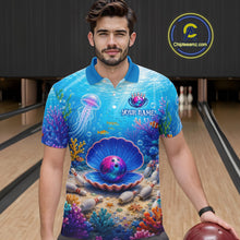 Load image into Gallery viewer, Man wearing a blue bowling shirt with ocean-themed design in a bowling alley.
