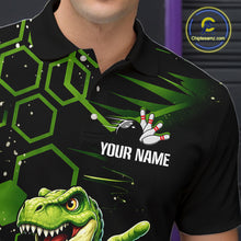 Load image into Gallery viewer, A close-up of a person wearing a black short-sleeve polo shirt with a green geometric pattern, a bowling pin graphic, and a green dinosaur graphic. The shirt has a placeholder text 'YOUR NAME' on the chest.