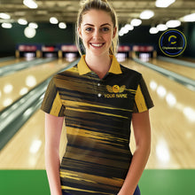 Load image into Gallery viewer, Female model wearing a custom black gold bowling polo shirt front view featuring a gold bowling ball emblem, dynamic gold brush stroke pattern and striped design at the bowling alley