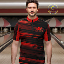 Load image into Gallery viewer, Male model wearing a custom black red bowling quarter-zip shirt front view featuring a red bowling ball emblem, dynamic red brush stroke pattern and striped design at the bowling alley