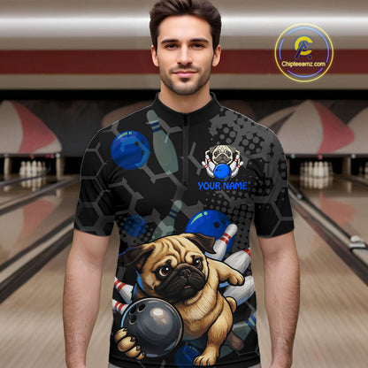 Man wearing a black bowling-themed shirt with a pug design in a bowling alley.