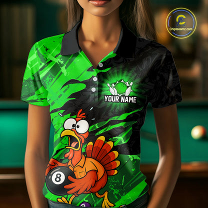 A woman wearing a short-sleeve polo shirt with a vibrant green and black abstract background and a cartoon turkey holding a 8-ball pool cue graphic on the front. The shirt has a black collar and a white customizable name print area.