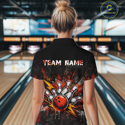 A woman viewed from behind wearing a black short-sleeve collared shirt with a bowling-themed graphic on the back. The design features the text 'TEAM NAME' above a hand striking a bowling ball with red, orange, yellow, and white paint-splatter effects.