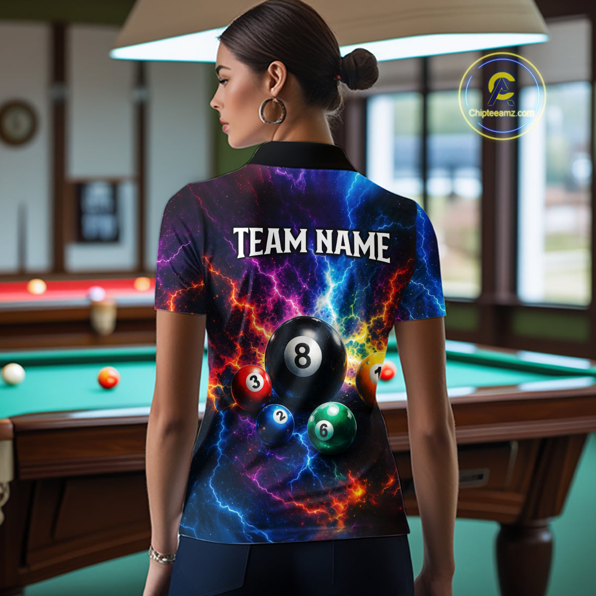 Person wearing a colorful shirt with billiard ball design in a pool hall.