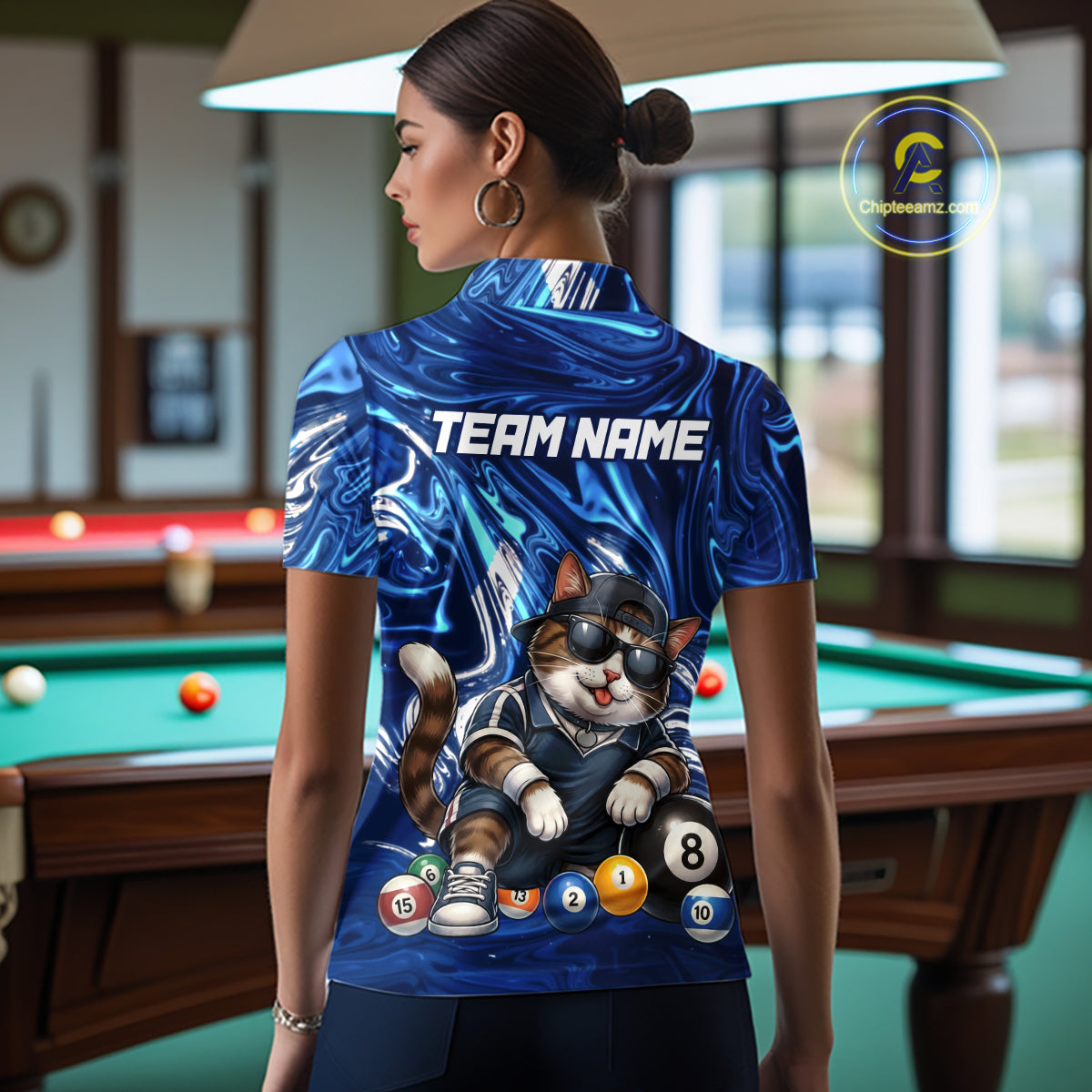 Person wearing a blue sports jersey with a cat graphic and 'TEAM NAME' text in a pool hall.