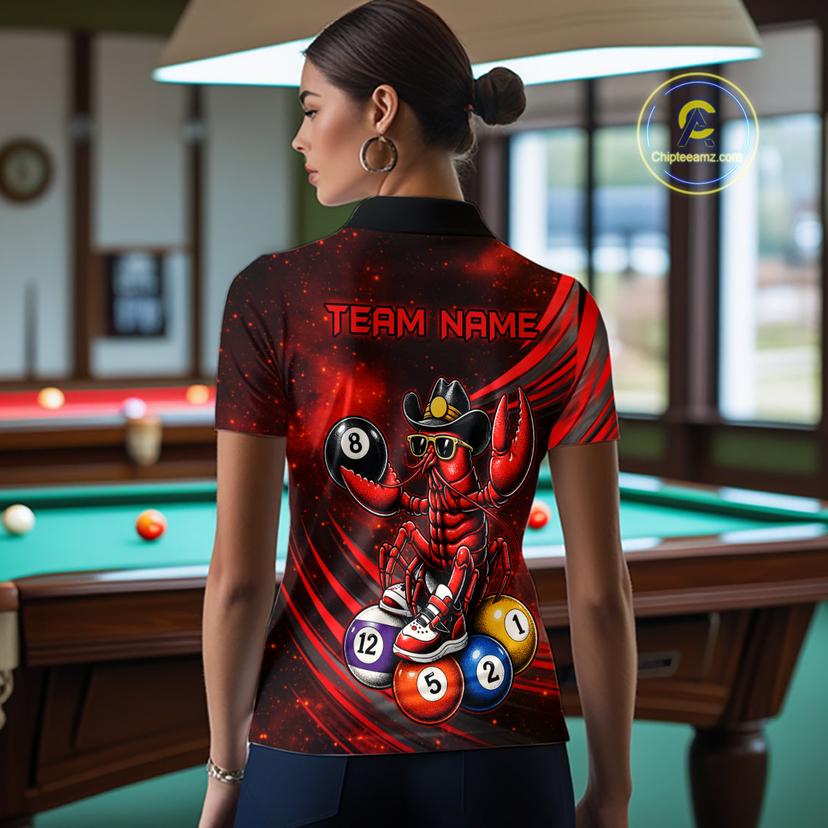 Person wearing a shirt with a red and black design featuring a crawfish and billiard balls in a pool hall.