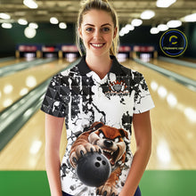 Load image into Gallery viewer, Woman wearing a bowling shirt with a cartoon character holding a bowling ball in a bowling alley.