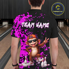 Load image into Gallery viewer, A person shown from the back wearing a black short-sleeve polo shirt with a bright purple paint-splatter design, white 'TEAM NAME' text, and a cartoon monkey graphic in an orange cap and sunglasses. Bowling alley lanes are visible in the background, and a circular 'Chipteamz'.