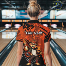 Load image into Gallery viewer, A woman viewed from behind wearing a short-sleeve bowling-themed polo shirt in a bowling alley. The shirt features a bold orange and black abstract pattern, the text 'TEAM NAME' across the upper back, and a cartoon monkey holding bowling balls near the lower back.