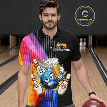 Load image into Gallery viewer, Man wearing a black t-shirt with colorful graphics and text, holding a bowling ball in a bowling alley.
